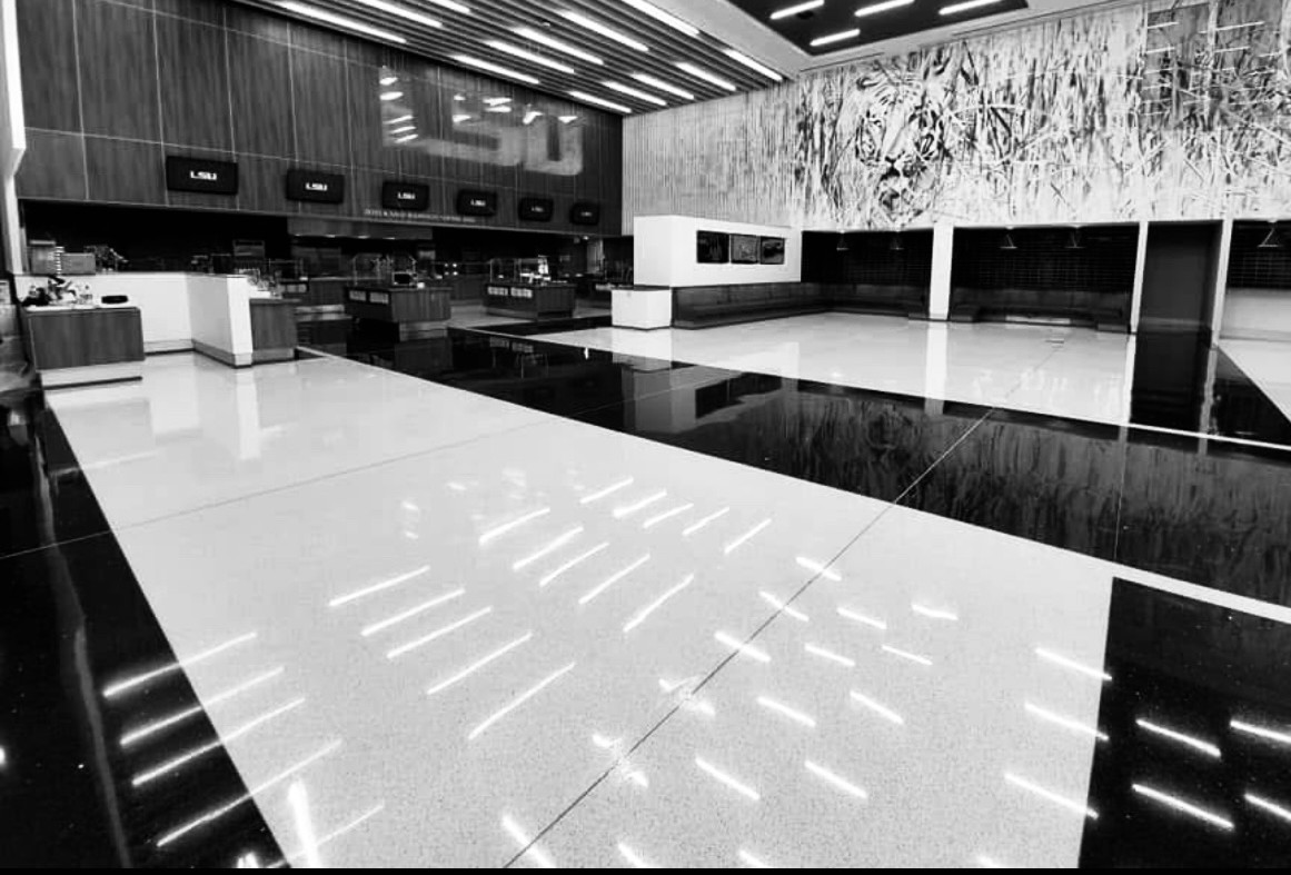 Freshly finished hard surface floor maintained by Third Coast Maintenance in a large cafeteria