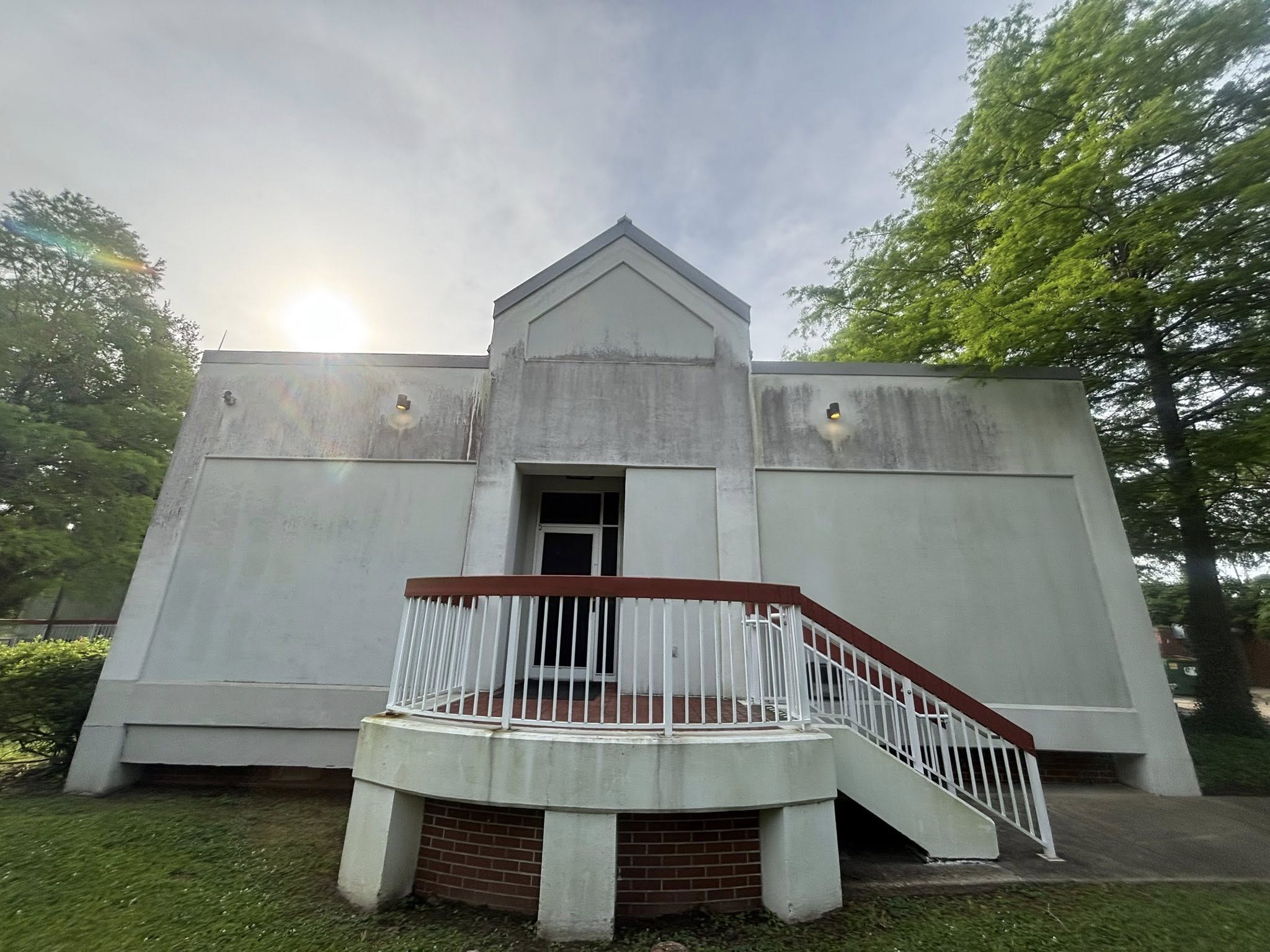 Museum stucco elevation before Third Coast Maintenance soft washing