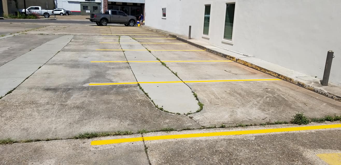 Freshly striped parking lot at a New Iberia, LA business by Third Coast Maintenance
